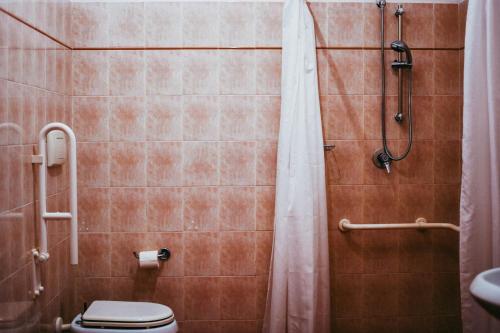 a bathroom with a shower with a toilet and a shower curtain at Agriturismo Vallerana in Capalbio