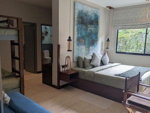 a bedroom with a bed and a large window at The Green Door in Ella