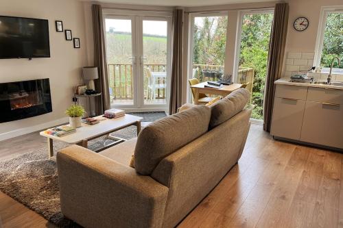 a living room with a couch and a table at The Hutch Devon in Longdown
