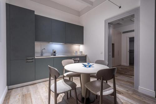 a kitchen with a table and chairs in a room at Old Theatre Suites - Favignana in Valletta