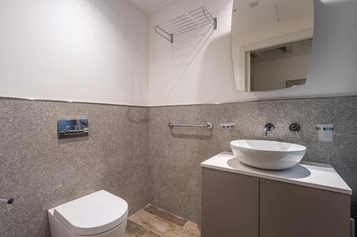 a bathroom with a sink and a toilet at Old Theatre Suites - Favignana in Valletta