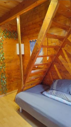 a room with a bed in a wooden cabin at Cozy cottage Paris Suburb! in Bobigny