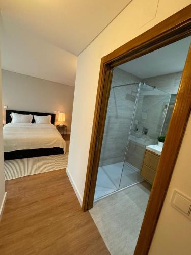 a bedroom with a bed and a glass shower at Your Lisbon Home Oriente in Lisbon