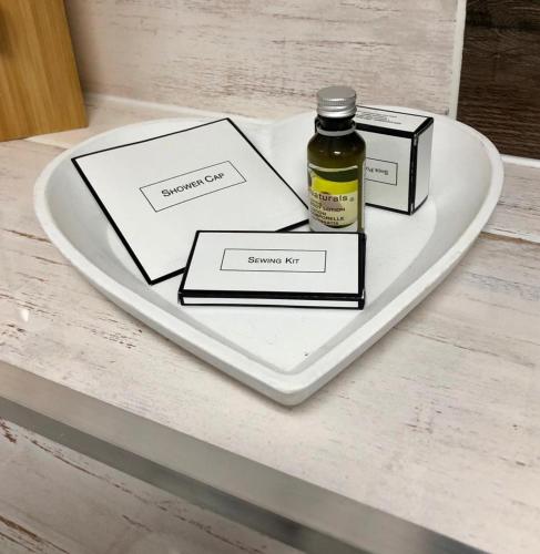 a bottle of essential oil sitting on a heart plate at Ferienwohnungen Traumschloss in Wernigerode