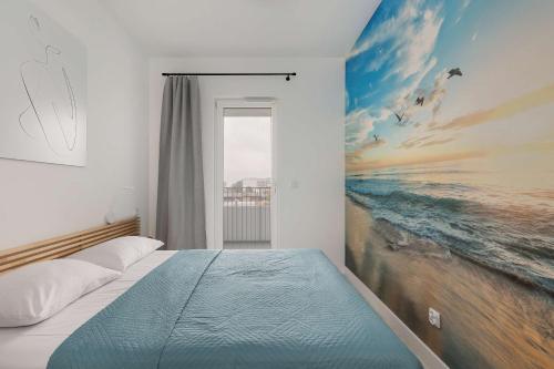 a bedroom with a bed with a painting on the wall at Baltic Waves Resort Stylish Apartment with Parking, Spa & Gym by Noclegi Renters in Międzyzdroje