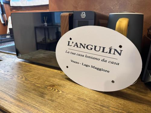 a sign that reads lencin sitting on a table at L'Angulìn in Vezzo
