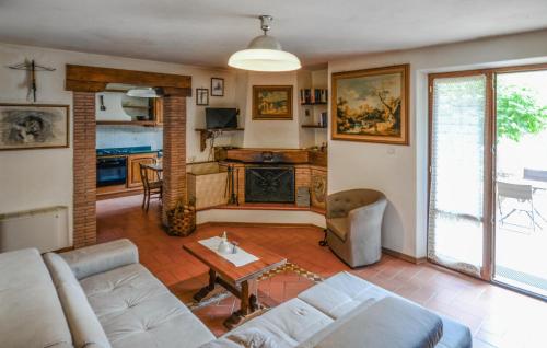 a living room with a couch and a fireplace at Lovely Home In Careggine in Careggine