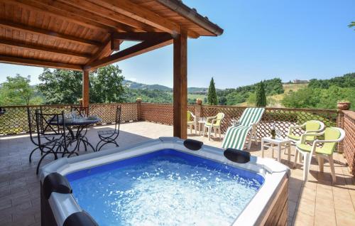 a hot tub on a patio with a table and chairs at 2 Bedroom Stunning Home In Casacastalda in Casa Castalda
