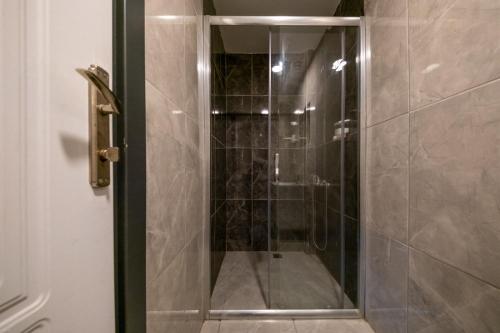 a shower with a glass door in a bathroom at Casa Nova Hotel in Istanbul
