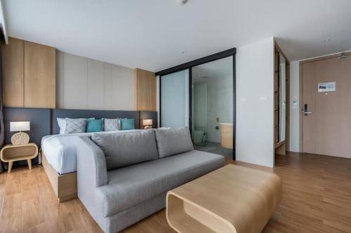 a living room with a bed and a couch at Wyndham Gardens Forrest View 1216 Studio in Nai Thon Beach