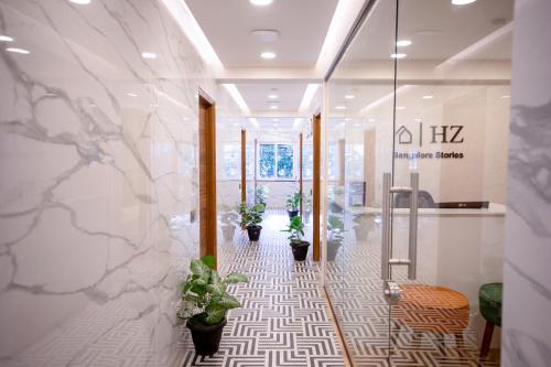 a lobby with potted plants on the wall at HZ Bangalore Stories in Bengaluru