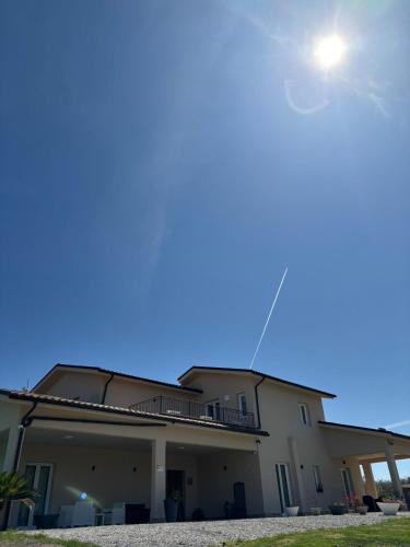 a house with a blue sky in the background at L'Oro Verde in Moricone