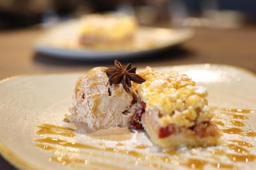 a plate of food with a dessert on a table at Planinarski dom Vošac in Makarska
