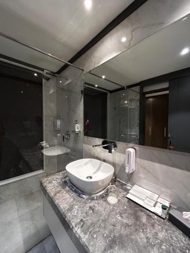 a bathroom with a sink and a mirror at Vaydantaa - Luxury Boutique Resort Mussoorie in Mussoorie