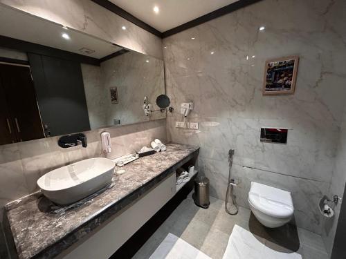 a bathroom with a sink and a toilet at Vaydantaa - Luxury Boutique Resort Mussoorie in Mussoorie