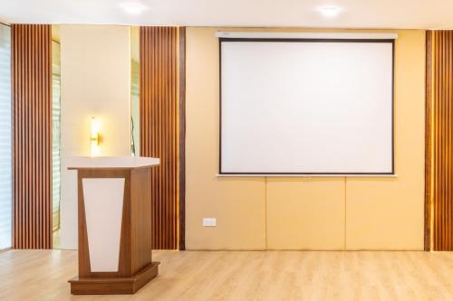 a projection screen in a room with a podium at HZ Bangalore Stories in Bengaluru