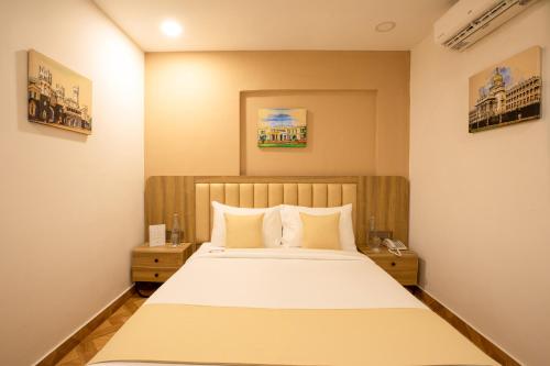 a bedroom with a bed and two night stands at HZ Bangalore Stories in Bengaluru