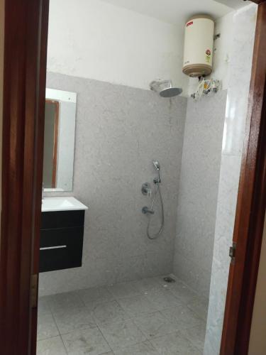 a bathroom with a shower and a sink at PUSHPAM RANCHES and RESORT in Hosūr