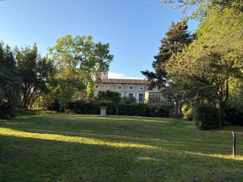 a large field of grass with a building in the background at SCI Domaine Saint Martin le grand in Béziers