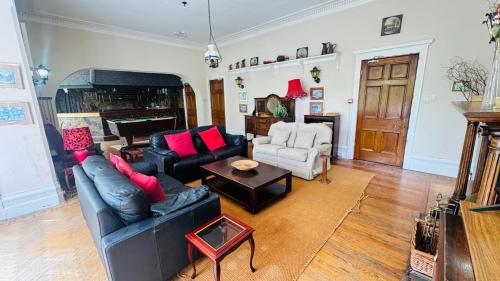 a living room with a couch and a table at Berthlwyd Country House in Conwy