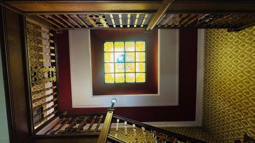 a staircase with a stained glass window in a building at Berthlwyd Country House in Conwy