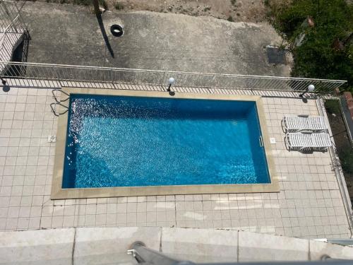 an overhead view of a swimming pool on a tile floor at Apartment Siana in Balchik