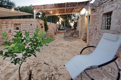 a white chair sitting on a patio at Trullo San Giovanni in Castellana Grotte