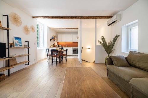 un salon avec un canapé et une table dans l'établissement L'EMERAUDE duplex confortable au cœur de Cannes, proche plage du Midi et Palais, à Cannes