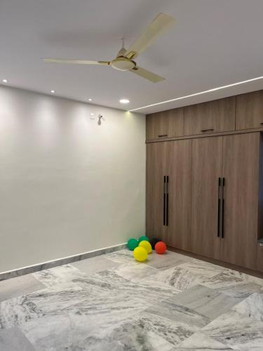 a room with a ceiling fan and balloons on the floor at Peaceful Private Residence in Hyderabad