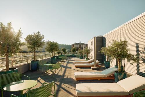 a balcony with tables and chairs on a building at Hotel Antik San Sebastián in Donostia-San Sebastián