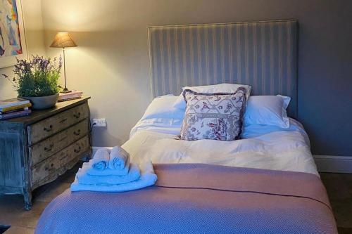 a bedroom with a bed with towels on it at 4-Bed House in Kildare Sleeps 8 with Parking in Kildare