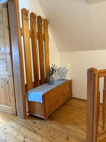 a bedroom with a wooden bed with a vase on it at Ferienwohnung Samahof in Stainz