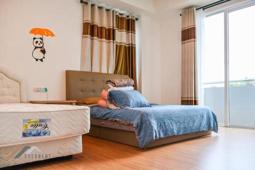 a bedroom with a bed and a large window at Serene Heights by Evernent in Miri