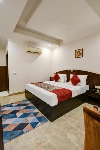 a bedroom with a large bed in a room at Airport La Sapphire Hotel & Restaurant in New Delhi