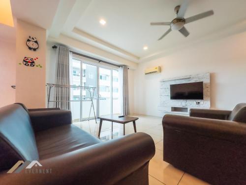 a living room with a couch and a tv at Serene Heights by Evernent in Miri
