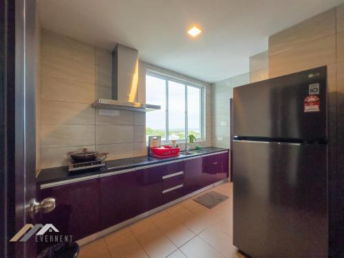 a kitchen with a stainless steel refrigerator and a window at Serene Heights by Evernent in Miri