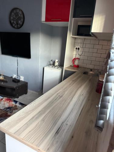a kitchen with a wooden counter top in a room at Ubuntu Lifestyle Estate - Phalaphala DeLux in Krugersdorp