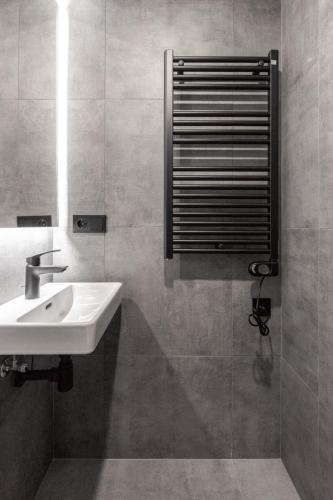 a bathroom with a sink and a mirror at Luxury Design Loft Escape In Riga in Rīga