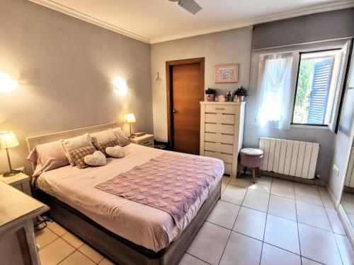 a bedroom with a bed with two pillows on it at Villa Tossalet VYB in El Tosalet