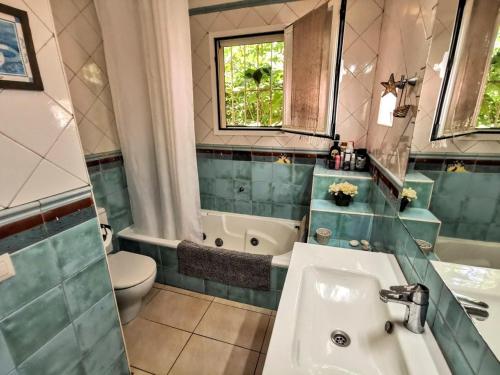 a bathroom with a tub and a sink and a toilet at Villa Tossalet VYB in El Tosalet