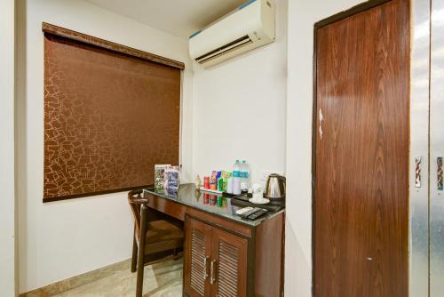 a room with a desk and a brown door at Airport La Sapphire Hotel & Restaurant in New Delhi