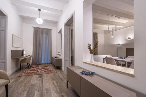 a living room with a large mirror on the wall at Old Theatre Suites - Elba in Valletta