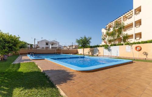 a swimming pool in a yard next to a building at Gorgeous Home In Orihuela in Villamartin