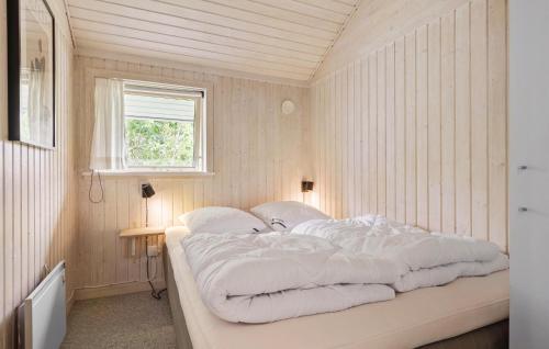 a bedroom with a large bed with white sheets at Lovely Home In Dronningmølle With Wifi in Dronningmølle