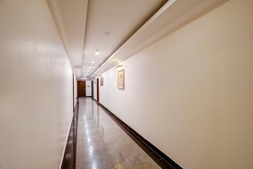 a hallway with a long corridor in a building at Airport La Sapphire Hotel & Restaurant in New Delhi