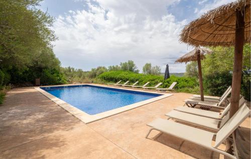 a swimming pool with lounge chairs and an umbrella at Finca Tortuga De Son Cifre in Manacor