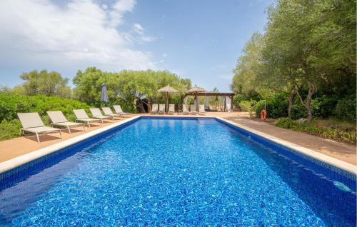 a swimming pool with chairs and a gazebo at Finca Tortuga De Son Cifre in Manacor