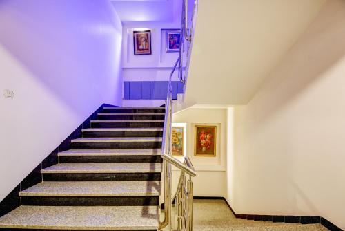 a staircase in a house with purple ceilings at Airport La Sapphire Hotel & Restaurant in New Delhi