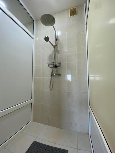 a bathroom with a shower with a glass door at Era Maris in Odesa