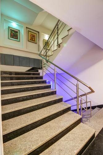 a set of stairs in a building with blue lighting at Airport La Sapphire Hotel & Restaurant in New Delhi